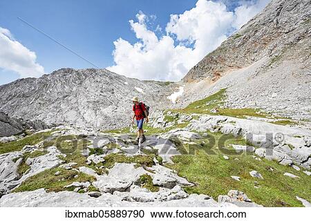 Hiker on hiking trail around the Funtenseetauern, landscape of washed out karst rocks, Steinernes Meer, Berchtesgaden National Park, Berchtesgadener Land, Upper Bavaria, Bavaria, Germany, Europe View Large Photo Image Stock Image - Hiker on hiking trail around the Funtenseetauern, landscape of washed out karst rocks, Steinernes Meer, Berchtesgaden National Park, Berchtesgadener Land, Upper Bavaria, Bavaria, Germany, Europe. Fotosearch