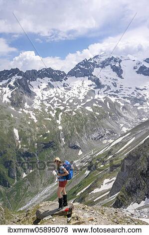 Stock Photo - Hiker on the descent from the Mörchnerscharte to the Floitengrund, behind Großer Löffler, Berliner Höhenweg, Zillertaler Alps, Zillertal, Tyrol, Austria, Europe. Fotosearch