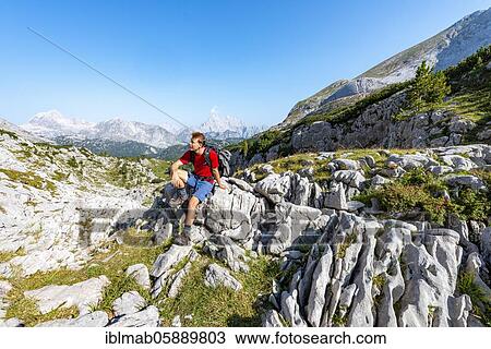 Hiker sitting on a stone, in the back summit of the Watzmann, hiking trail in the Funtenseetauern, Steinernes Meer, Berchtesgaden National Park, Berchtesgadener Land, Upper Bavaria, Bavaria, Germany, Europe View Large Photo Image Stock Image - Hiker sitting on a stone, in the back summit of the Watzmann, hiking trail in the Funtenseetauern, Steinernes Meer, Berchtesgaden National Park, Berchtesgadener Land, Upper Bavaria, Bavaria, Germany, Europe. Fotosearch