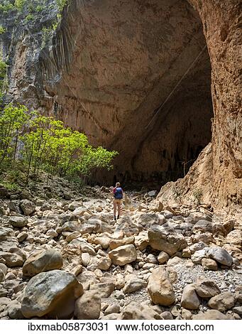 Stock Image - Hiker stands in a gorge, steep cliffs of Garganta Verde, Sierra de Cádiz, province of Cádiz, Spain, Europe. Fotosearch