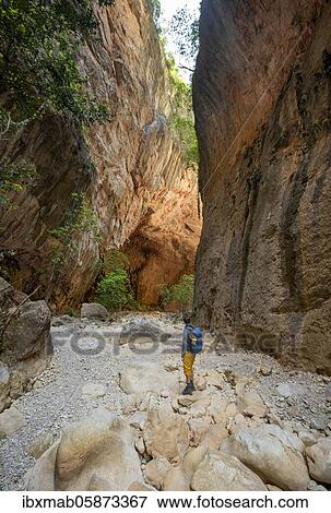 Stock Photo - Hiker stands in a gorge, steep cliffs of Garganta Verde, Sierra de Cádiz, province of Cádiz, Spain, Europe. Fotosearch