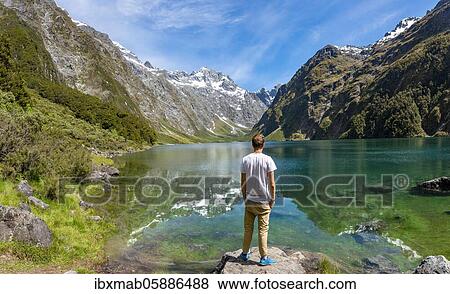 Hiker stands on shore, Lake Marian, Fiordland National Park, Te Anau, Southland, South Island, New Zealand, Oceania View Large Photo Image Stock Photo - Hiker stands on shore, Lake Marian, Fiordland National Park, Te Anau, Southland, South Island, New Zealand, Oceania. Fotosearch