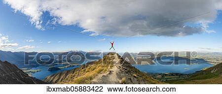 Hiker takes a skydive, views of mountains and lake from Mount Roy, Roys Peak, Lake Wanaka, Southern Alps, Otago, South Island, New Zealand, Oceania View Large Photo Image Stock Image - Hiker takes a skydive, views of mountains and lake from Mount Roy, Roys Peak, Lake Wanaka, Southern Alps, Otago, South Island, New Zealand, Oceania. Fotosearch