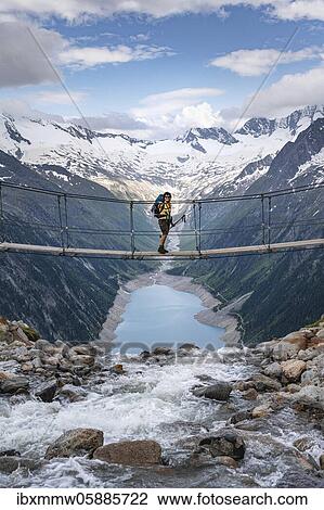 Hiker, woman on suspension bridge at the Olpererhütte, Schlegeis reservoir, Schlegeis reservoir, Zillertal Alps, Schlegeiskees glacier, Zillertal, Tyrol, Austria, Europe View Large Photo Image Stock Image - Hiker, woman on suspension bridge at the Olpererhütte, Schlegeis reservoir, Schlegeis reservoir, Zillertal Alps, Schlegeiskees glacier, Zillertal, Tyrol, Austria, Europe. Fotosearch
