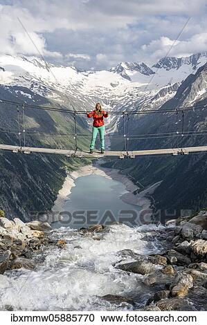 Hiker, woman on suspension bridge at the Olpererhütte, Schlegeis reservoir, Schlegeis reservoir, Zillertal Alps, Schlegeiskees glacier, Zillertal, Tyrol, Austria, Europe View Large Photo Image Stock Image - Hiker, woman on suspension bridge at the Olpererhütte, Schlegeis reservoir, Schlegeis reservoir, Zillertal Alps, Schlegeiskees glacier, Zillertal, Tyrol, Austria, Europe. Fotosearch
