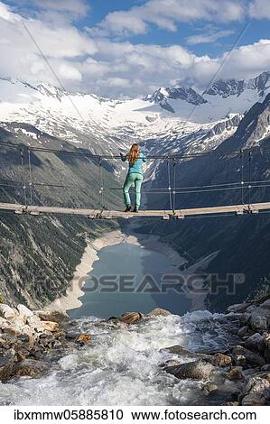 Hiker, woman on suspension bridge at the Olpererhütte, Schlegeis reservoir, Schlegeis reservoir, Zillertal Alps, Schlegeiskees glacier, Zillertal, Tyrol, Austria, Europe View Large Photo Image Stock Image - Hiker, woman on suspension bridge at the Olpererhütte, Schlegeis reservoir, Schlegeis reservoir, Zillertal Alps, Schlegeiskees glacier, Zillertal, Tyrol, Austria, Europe. Fotosearch