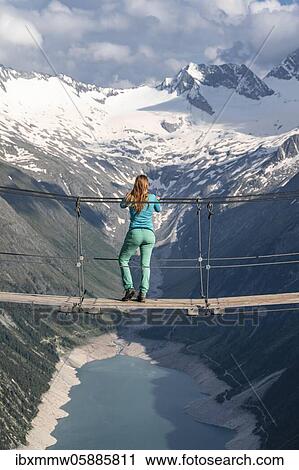 Hiker, woman on suspension bridge at the Olpererhütte, Schlegeis reservoir, Schlegeis reservoir, Zillertal Alps, Schlegeiskees glacier, Zillertal, Tyrol, Austria, Europe View Large Photo Image Stock Image - Hiker, woman on suspension bridge at the Olpererhütte, Schlegeis reservoir, Schlegeis reservoir, Zillertal Alps, Schlegeiskees glacier, Zillertal, Tyrol, Austria, Europe. Fotosearch