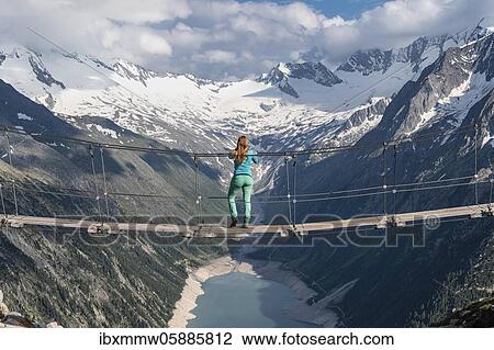 Hiker, woman on suspension bridge at the Olpererhütte, Schlegeis reservoir, Schlegeis reservoir, Zillertal Alps, Schlegeiskees glacier, Zillertal, Tyrol, Austria, Europe View Large Photo Image Stock Image - Hiker, woman on suspension bridge at the Olpererhütte, Schlegeis reservoir, Schlegeis reservoir, Zillertal Alps, Schlegeiskees glacier, Zillertal, Tyrol, Austria, Europe. Fotosearch