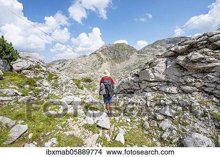 Picture - Hikers in a landscape of washed out karst rocks, Funtenseetauern, Steinernes Meer, Berchtesgaden National Park, Berchtesgadener Land, Upper Bavaria, Bavaria, Germany, Europe. Fotosearch