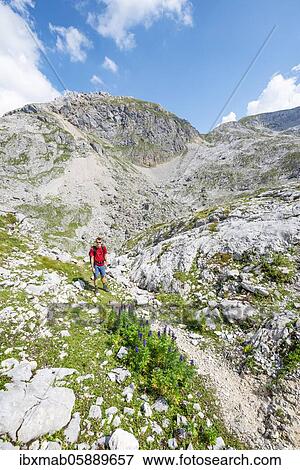 Stock Photo - Hikers in a landscape of washed out karst rocks, Funtenseetauern, Steinernes Meer, Berchtesgaden National Park, Berchtesgadener Land, Upper Bavaria, Bavaria, Germany, Europe. Fotosearch