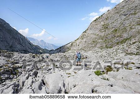 Stock Photo - Hikers in a landscape of washed out karst rocks, Funtenseetauern, Steinernes Meer, Berchtesgaden National Park, Berchtesgadener Land, Upper Bavaria, Bavaria, Germany, Europe. Fotosearch