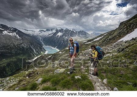 Hikers on the Berliner Höhenweg, Schlegeis reservoir, Schlegeis reservoir, Zillertal Alps, Schlegeiskees glacier, Zillertal, Tyrol, Austria, Europe View Large Photo Image Stock Image - Hikers on the Berliner Höhenweg, Schlegeis reservoir, Schlegeis reservoir, Zillertal Alps, Schlegeiskees glacier, Zillertal, Tyrol, Austria, Europe. Fotosearch