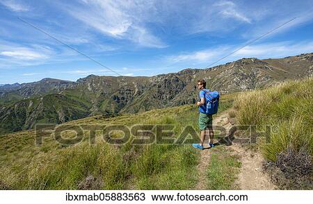 Stock Image - Hikers on trail, Grandview Mountain Track, Lake Hāwea, Southern Alps, Otago, South Island, New Zealand, Oceania. Fotosearch