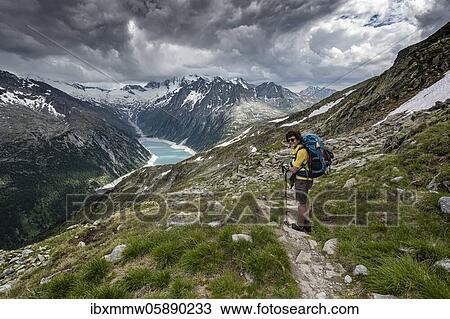 Hiking on the Berlin High Altitude Trail, Schlegeis Reservoir, Schlegeis reservoir, Zillertal Alps, Schlegeiskees Glacier, Zillertal, Tyrol, Austria, Europe View Large Photo Image Stock Image - Hiking on the Berlin High Altitude Trail, Schlegeis Reservoir, Schlegeis reservoir, Zillertal Alps, Schlegeiskees Glacier, Zillertal, Tyrol, Austria, Europe. Fotosearch