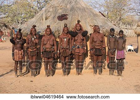 Picture - Himba women in front of their hut, Kaokoveld, Namibia, Africa. Fotosearch