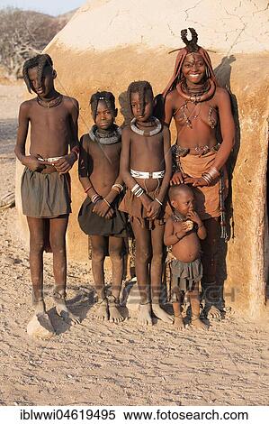 Stock Photography - Himbafrau and children in front of a mud hut, Kaokoveld, Kunene, Namibia, Africa. Fotosearch
