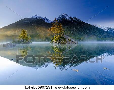 Hintersee with morning fog at sunrise, water reflection, behind Hochkalter, Berchtesgaden National Park, Ramsau, Upper Bavaria, Bavaria, Germany, Europe View Large Photo Image Stock Image - Hintersee with morning fog at sunrise, water reflection, behind Hochkalter, Berchtesgaden National Park, Ramsau, Upper Bavaria, Bavaria, Germany, Europe. Fotosearch