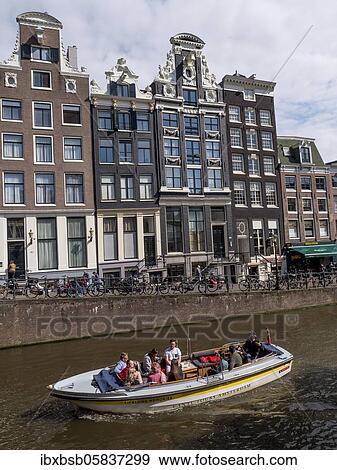 Historic buildings along the Rokin Canal and a tourist boat, Amsterdam, Netherlands View Large Photo Image Stock Photo - Historic buildings along the Rokin Canal and a tourist boat, Amsterdam, Netherlands. Fotosearch