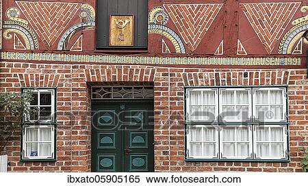 Stock Photography - Historical half-timbered house with crooked beams and modern inscription to protect against demolition, Old Town, Lüneburg, Lower Saxony, Germany, Europe. Fotosearch