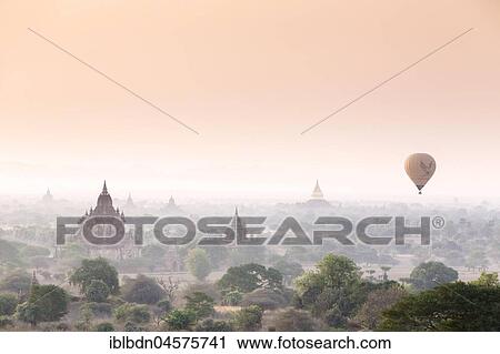 Stock Image - Hot air balloon over Bagan temples at sunrise, Bagan, Division Mandalay, Myanmar, Asia. Fotosearch