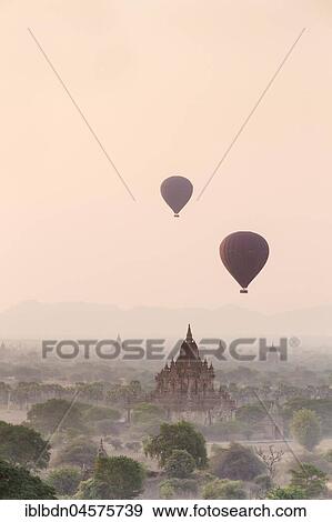 Stock Photo - Hot air balloon over Bagan temples at sunrise, Bagan, Division Mandalay, Myanmar, Asia. Fotosearch