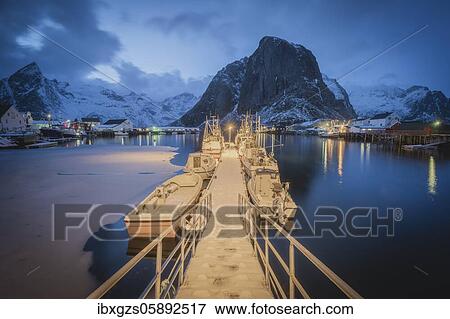Stock Photo - Illuminated landing stage, jetty at the harbour of the fishing village Hamnoy Polar Night in winter, Reinefjord, Moskenesøya, Reine, Nordland, Lofoten, Norway, Europe. Fotosearch