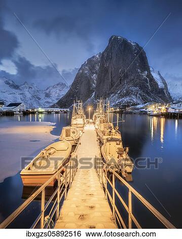 Illuminated landing stage, jetty at the harbour of the fishing village Hamnoy Polar Night in winter, Reinefjord, Moskenesøya, Reine, Nordland, Lofoten, Norway, Europe View Large Photo Image Stock Photograph - Illuminated landing stage, jetty at the harbour of the fishing village Hamnoy Polar Night in winter, Reinefjord, Moskenesøya, Reine, Nordland, Lofoten, Norway, Europe. Fotosearch