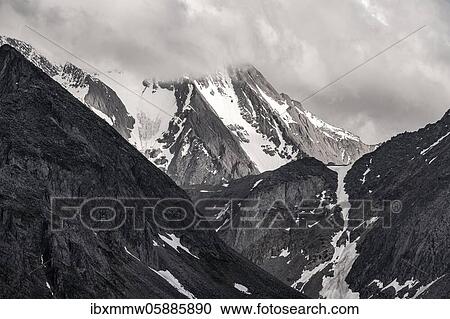 In clouds wrapped snow-covered mountain, dramatic mountain landscape, Zillertal Alps, Zillertal, Tyrol, Austria, Europe View Large Photo Image Stock Image - In clouds wrapped snow-covered mountain, dramatic mountain landscape, Zillertal Alps, Zillertal, Tyrol, Austria, Europe. Fotosearch