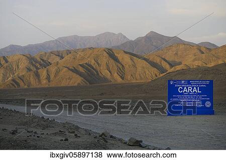 Stock Photo - Info board of the ruins of Caral, oldest city in America, Unesco World Heritage Site, Valley of the Rio Supe, Peru, South America. Fotosearch