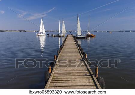 Jetty with sailboats at the Dümmer, Binnensee, Lembruch, Lower Saxony, Germany, Europe View Large Photo Image Stock Image - Jetty with sailboats at the Dümmer, Binnensee, Lembruch, Lower Saxony, Germany, Europe. Fotosearch