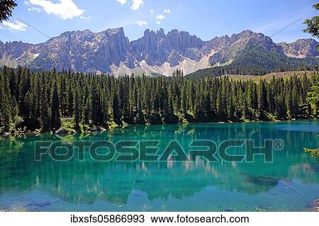 Stock Image - Lake Carezza, Lago di Carezza, with Latemar Group in the background, Dolomites, South Tyrol, Italy, Europe. Fotosearch