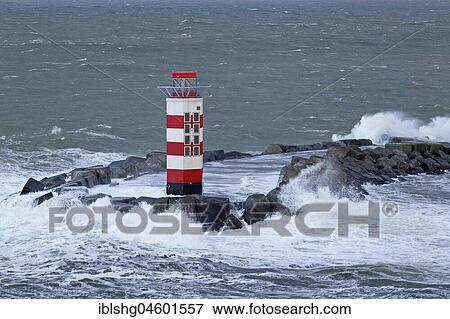 Stock Photo - Lighthouse in the harbour entrance, Ijmuiden, Netherlands. Fotosearch