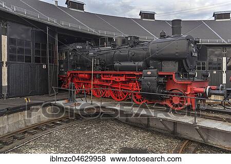 Locomotive 38 2383 year of construction 1918 for passenger train, pushed by a shunting locomotive into the engine shed, Deutsches Dampflokmuseum Museum, Neuenmarkt, Upper Franconia, Bavaria, Germany, Europe View Large Photo Image Stock Photo - Locomotive 38 2383 year of construction 1918 for passenger train, pushed by a shunting locomotive into the engine shed, Deutsches Dampflokmuseum Museum, Neuenmarkt, Upper Franconia, Bavaria, Germany, Europe. Fotosearch
