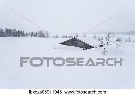 Stock Photography - Lonely wooden house in wide landscape in snow in winter, behind forest, Muonio, Lapland, Finland, Europe. Fotosearch