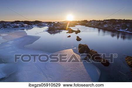 Low sun over a half frozen fjord, Dønna, Nordland, Norway, Europe View Large Photo Image Stock Photo - Low sun over a half frozen fjord, Dønna, Nordland, Norway, Europe. Fotosearch