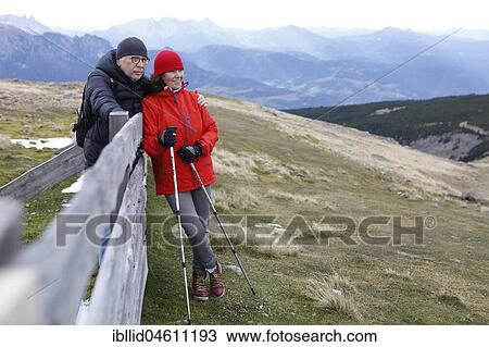 Stock Image - Man and woman, couple during Nordic Walking in the mountains, Rittner Horn, South Tyrol, Italy, Europe. Fotosearch