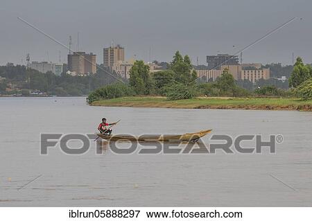 Stock Photo - Man in canoe on the Niger river, Niamey, Niger, Africa. Fotosearch