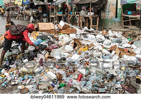 Stock Photo - Man rummages in garbage, garbage dump, roadside, Port-au-Prince, Ouest, Haiti, Central America. Fotosearch