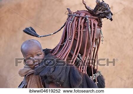 Stock Image - Married Himbafrau carries toddler, portrait, Kaokoveld, Namibia, Africa. Fotosearch