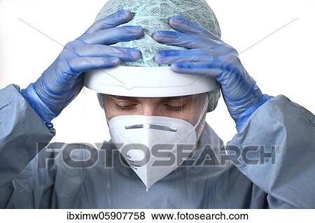 Stock Photo - Medical staff overworked, gestures, hands over head, corona crisis, Baden-Württemberg, Germany, Europe. Fotosearch