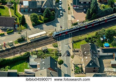 Stock Image - Millingen railway crossing main road with regional train, Betuweline, Rees, Lower Rhine, Rhine, North Rhine-Westphalia, Germany, Europe. Fotosearch