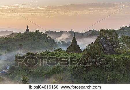 Mist over hills and stupas of Mrauk U at sunrise, Burma, Myanmar, Asia View Large Photo Image Stock Image - Mist over hills and stupas of Mrauk U at sunrise, Burma, Myanmar, Asia. Fotosearch