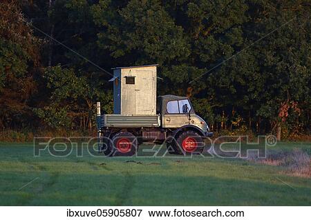 Mobile hunting seat mounted on a Unimog standing in a meadow at the edge of a forest in the evening light, Schleswig-Holstein, Germany, Europe View Large Photo Image Stock Photo - Mobile hunting seat mounted on a Unimog standing in a meadow at the edge of a forest in the evening light, Schleswig-Holstein, Germany, Europe. Fotosearch