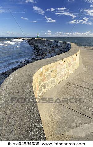 Stock Photography - Mole with lighthouse in the harbour, Westmole, Warnemünde, Mecklenburg-Western Pomerania, Germany, Europe. Fotosearch