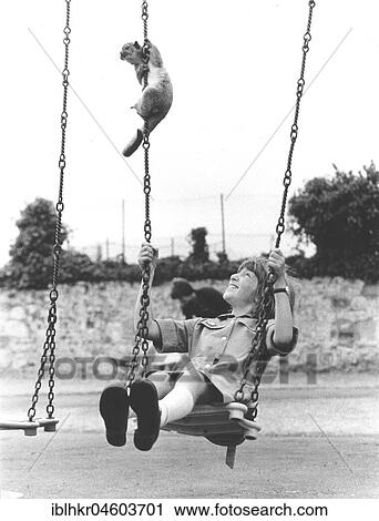 Monkey and child on a swing, England, Great Britain View Large Photo Image Stock Image - Monkey and child on a swing, England, Great Britain. Fotosearch
