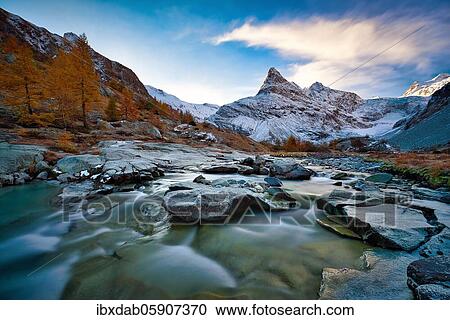 Morning atmosphere at the creek near Ferpècle, behind it snowy Mont Miné, Val d'Hérens, Canton Valais, Switzerland, Europe View Large Photo Image Stock Image - Morning atmosphere at the creek near Ferpècle, behind it snowy Mont Miné, Val d'Hérens, Canton Valais, Switzerland, Europe. Fotosearch
