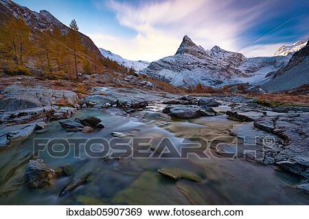 Morning atmosphere at the creek near Ferpècle, behind it snowy Mont Miné, Val d'Hérens, Canton Valais, Switzerland, Europe View Large Photo Image Stock Photo - Morning atmosphere at the creek near Ferpècle, behind it snowy Mont Miné, Val d'Hérens, Canton Valais, Switzerland, Europe. Fotosearch