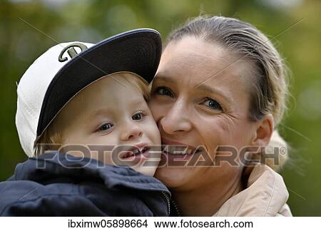 Picture - Mother holds son, 2 years old, in her arms, Stuttgart Baden-Württemberg, Germany, Europe. Fotosearch