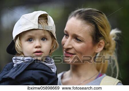 Stock Photo - Mother holds son, 2 years old, in her arms, Stuttgart Baden-Württemberg, Germany, Europe. Fotosearch