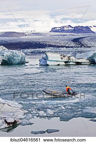 Stock Image - Motorboat in glacier lagoon Jökulsárlón, glacier tongue of Vatnajökull Glacier, Vatnajökull National Park, Hornarfjoerdur, East Iceland, Iceland, Europe. Fotosearch